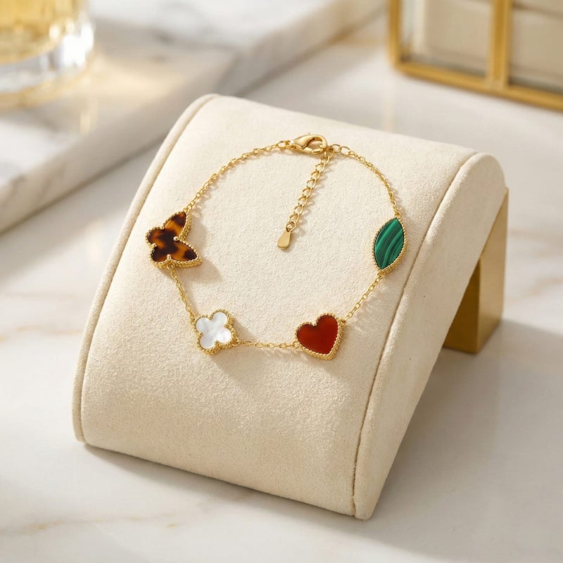 A delicate gold-tone bracelet crafted from rust-resistant stainless steel, adorned with royal green and mother-of-pearl white motifs featuring a butterfly and heart design. It has an adjustable clasp for a perfect fit. - Image 4